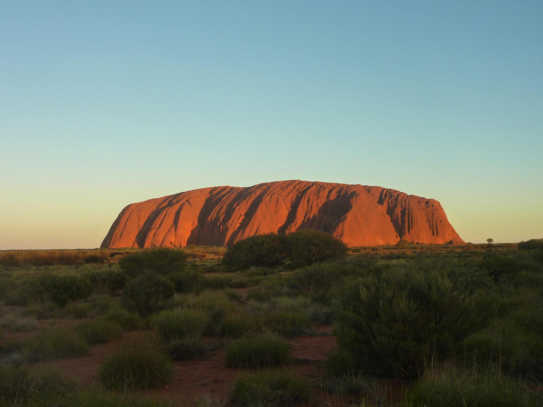 Uluru Ayers Rock Australia red sandstone monolith sunset desert scrub