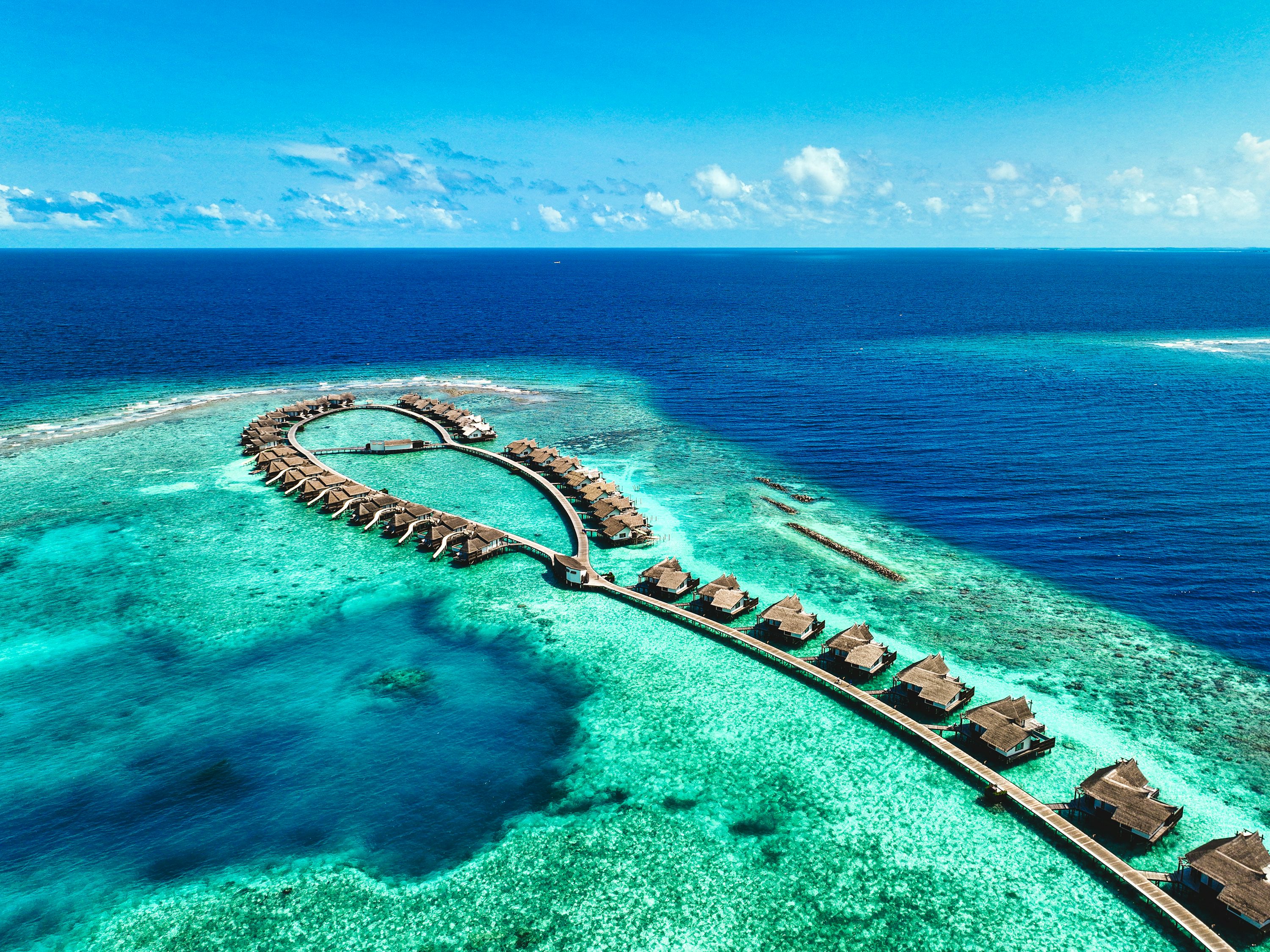 Cook Islands overwater bungalows turquoise Pacific lagoon aerial