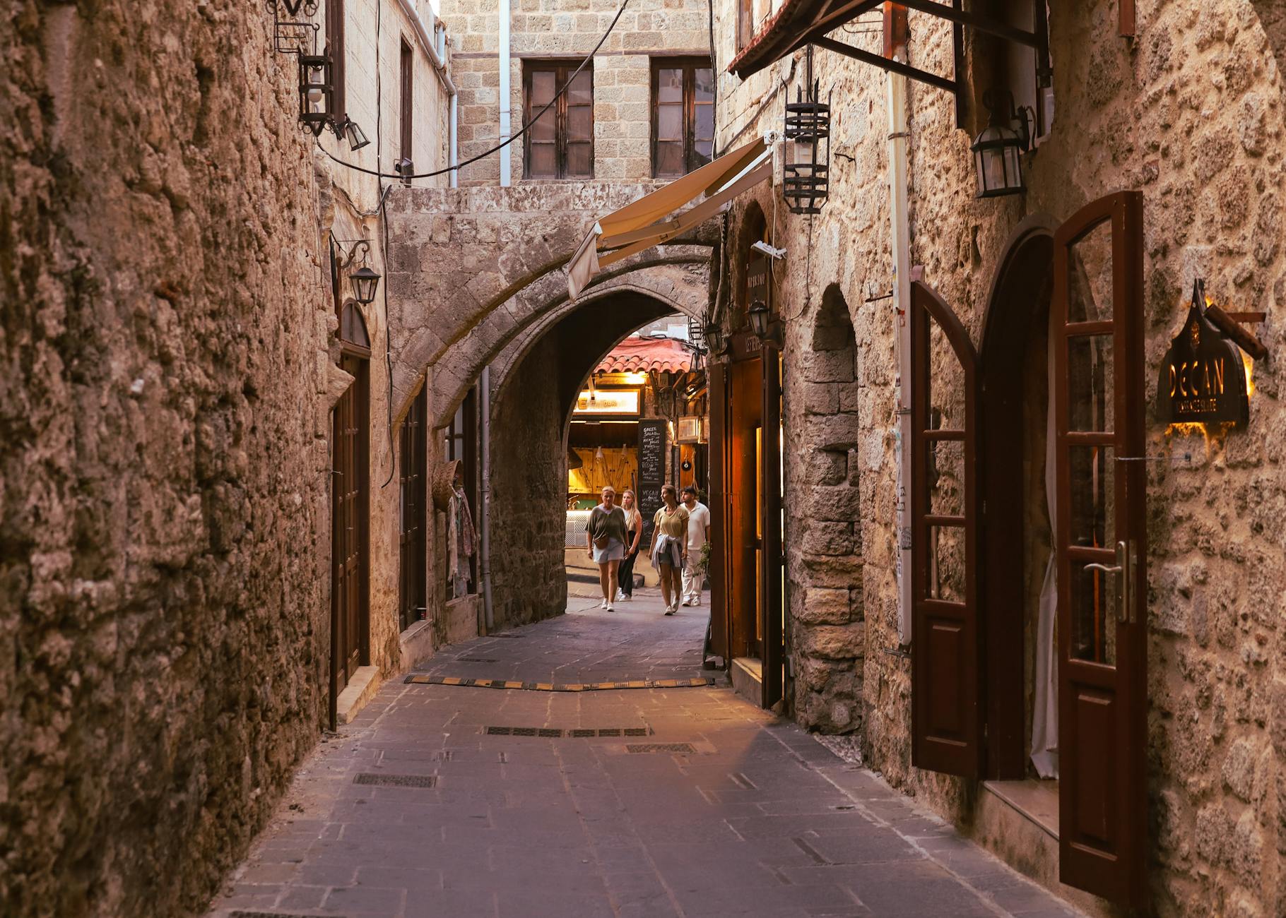 Rhodes Old Town medieval cobblestone alley stone arches Greece