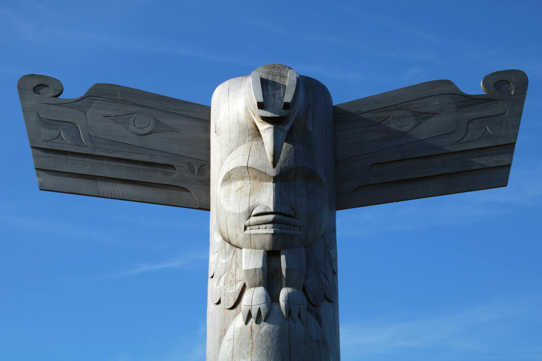 Ketchikan Alaska Tlingit totem pole thunderbird carved wood blue sky