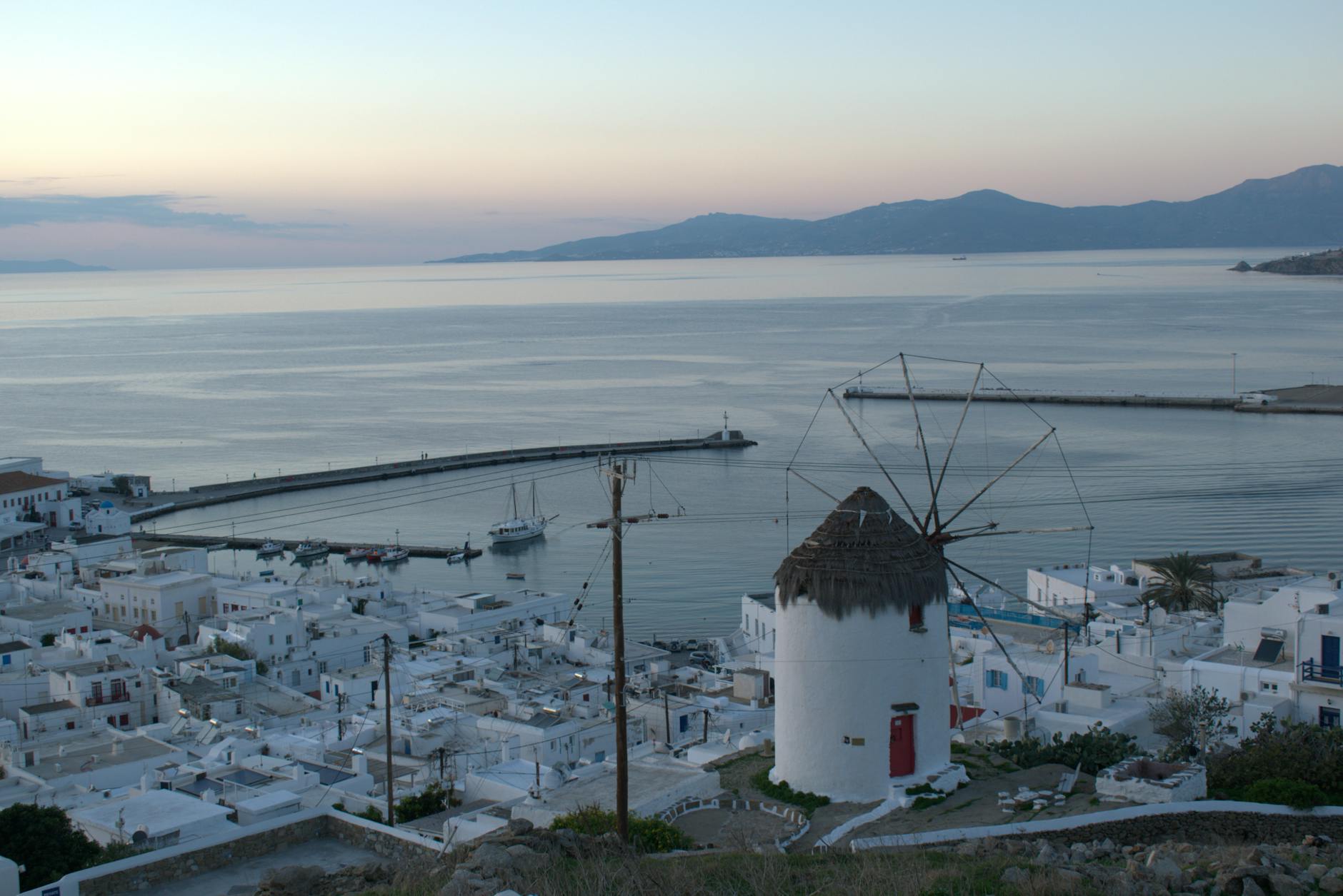 Mykonos Chora town windmill harbour aerial view Aegean Sea dusk