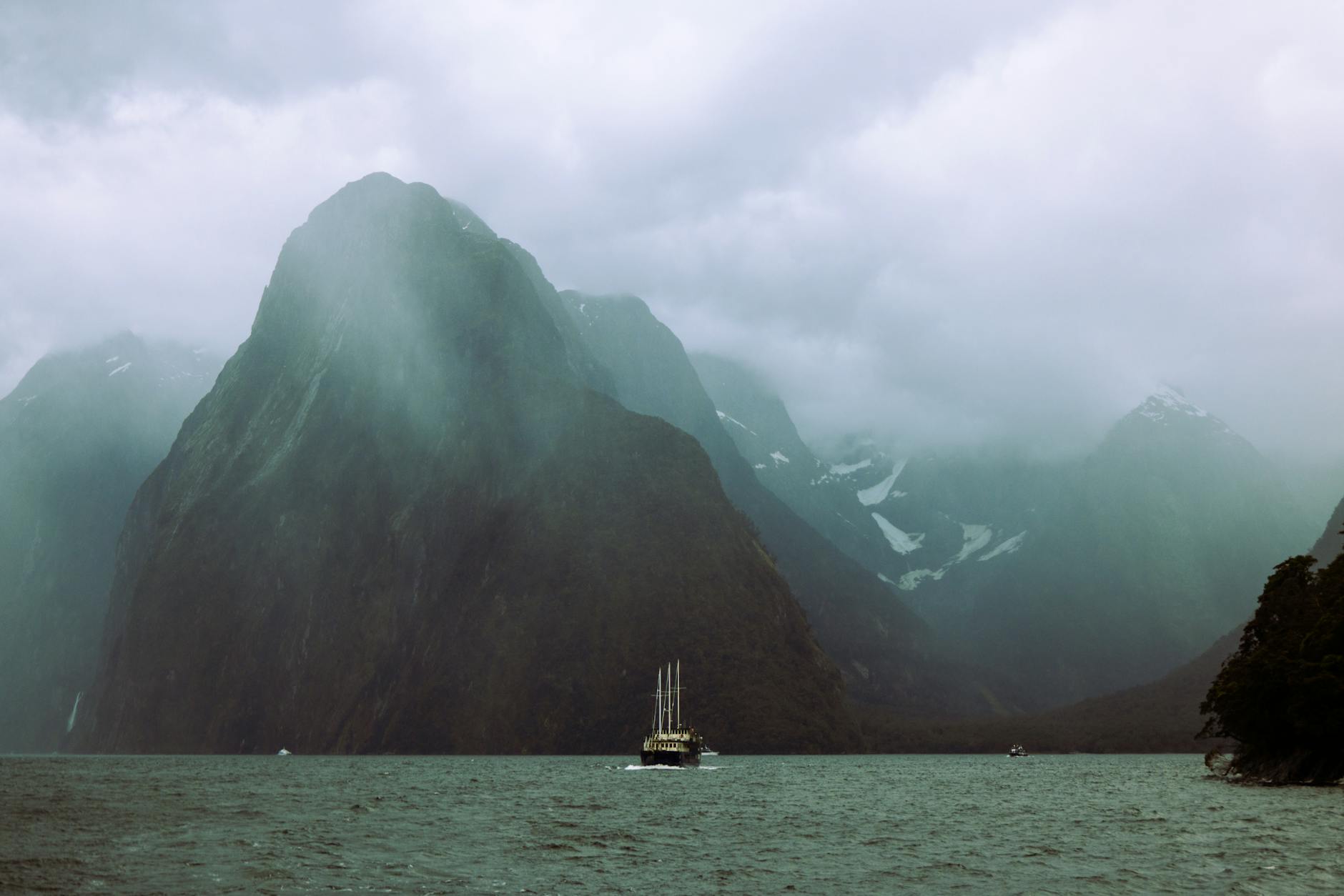 Milford Sound New Zealand Fiordland fjord misty mountains cruise boat