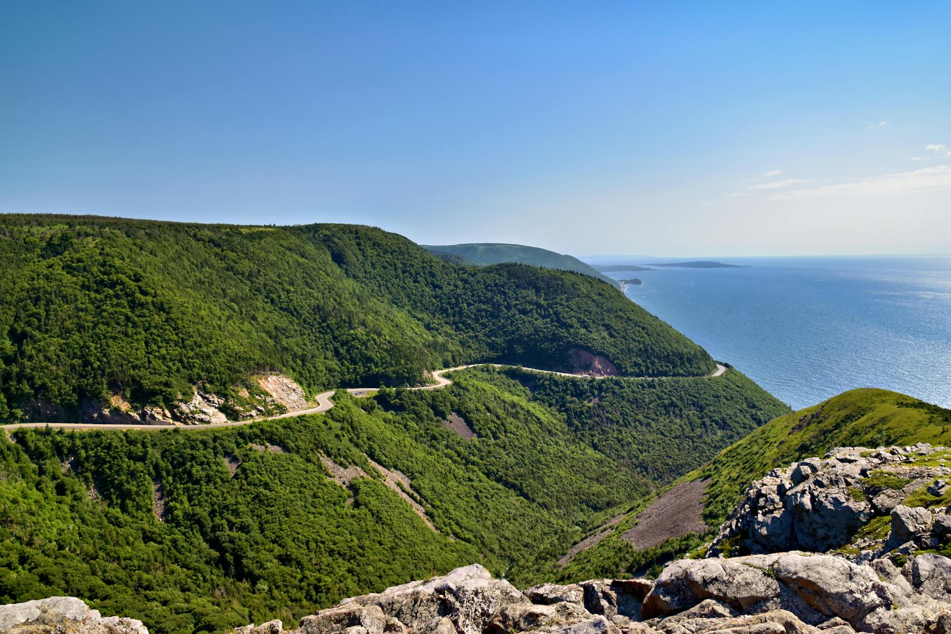 Cape Breton Highlands Nova Scotia Canada Cabot Trail winding road summer green hillside ocean