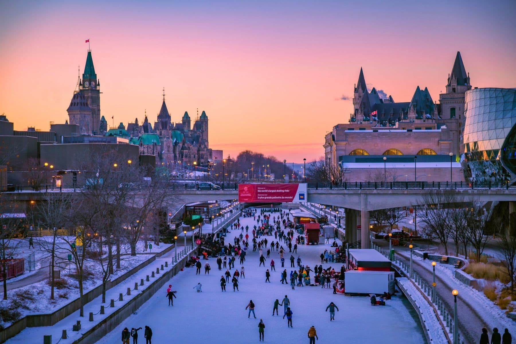 Rideau Canal Ottawa Canada skating at sunset with Parliament Hill in background