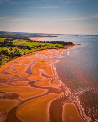 Prince Edward Island aerial view red sand tidal flats and green farmland PEI Canada