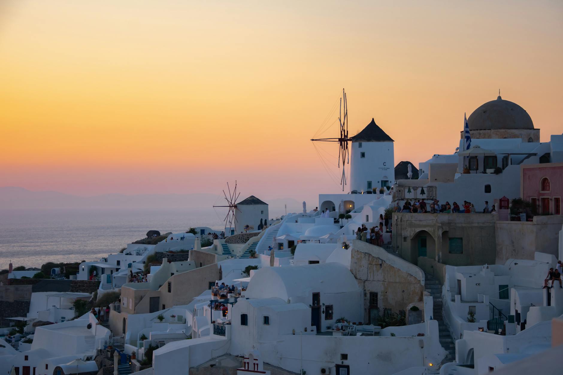 Santorini Oia windmills sunset orange sky white buildings Greece