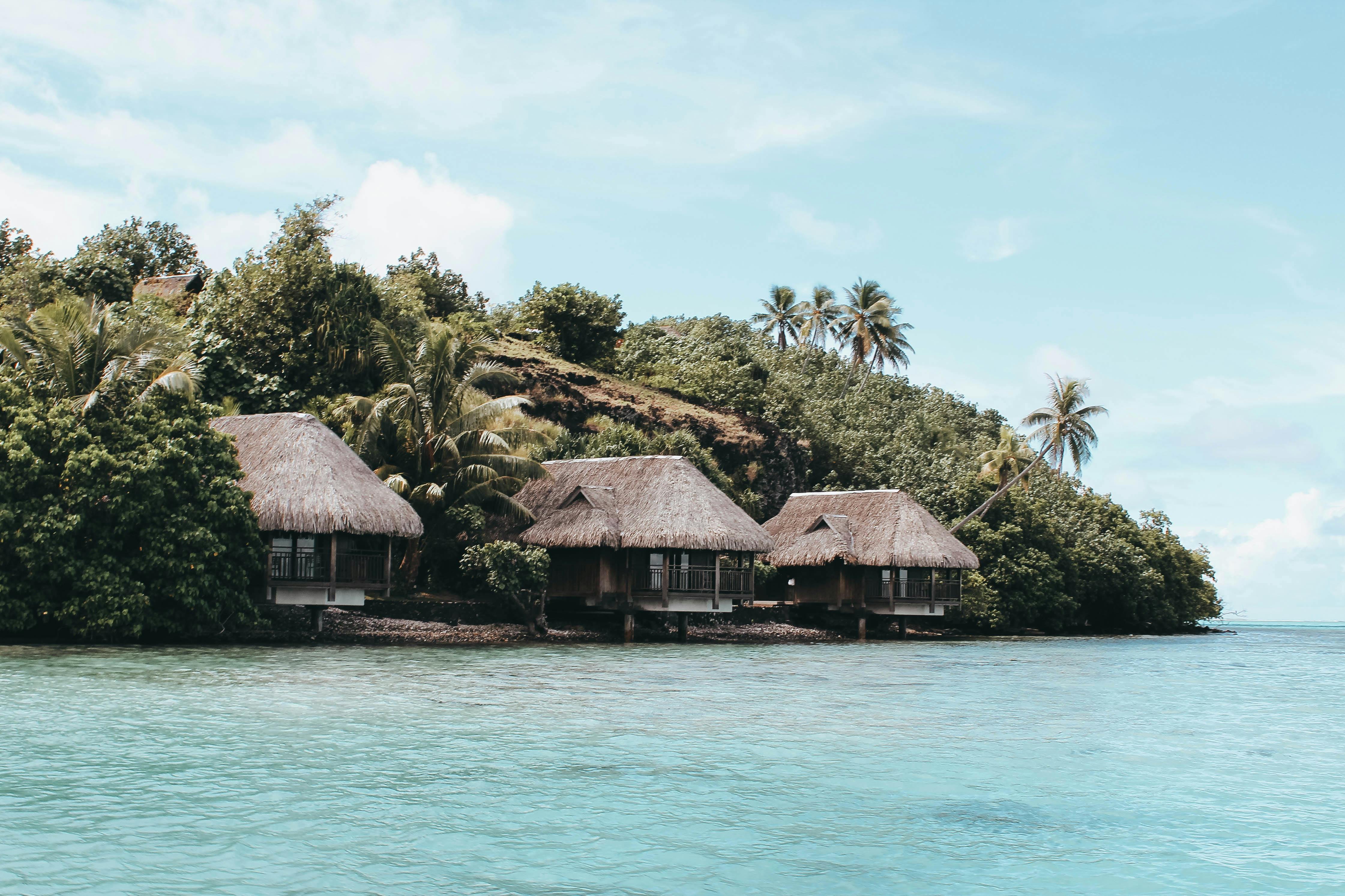 French Polynesia overwater bungalows thatched roof tropical island lagoon