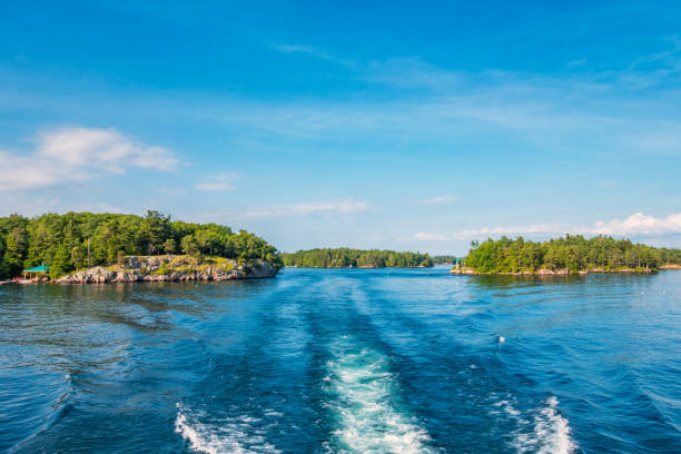 Boat cruising through Thousand Islands Ontario Canada St Lawrence River