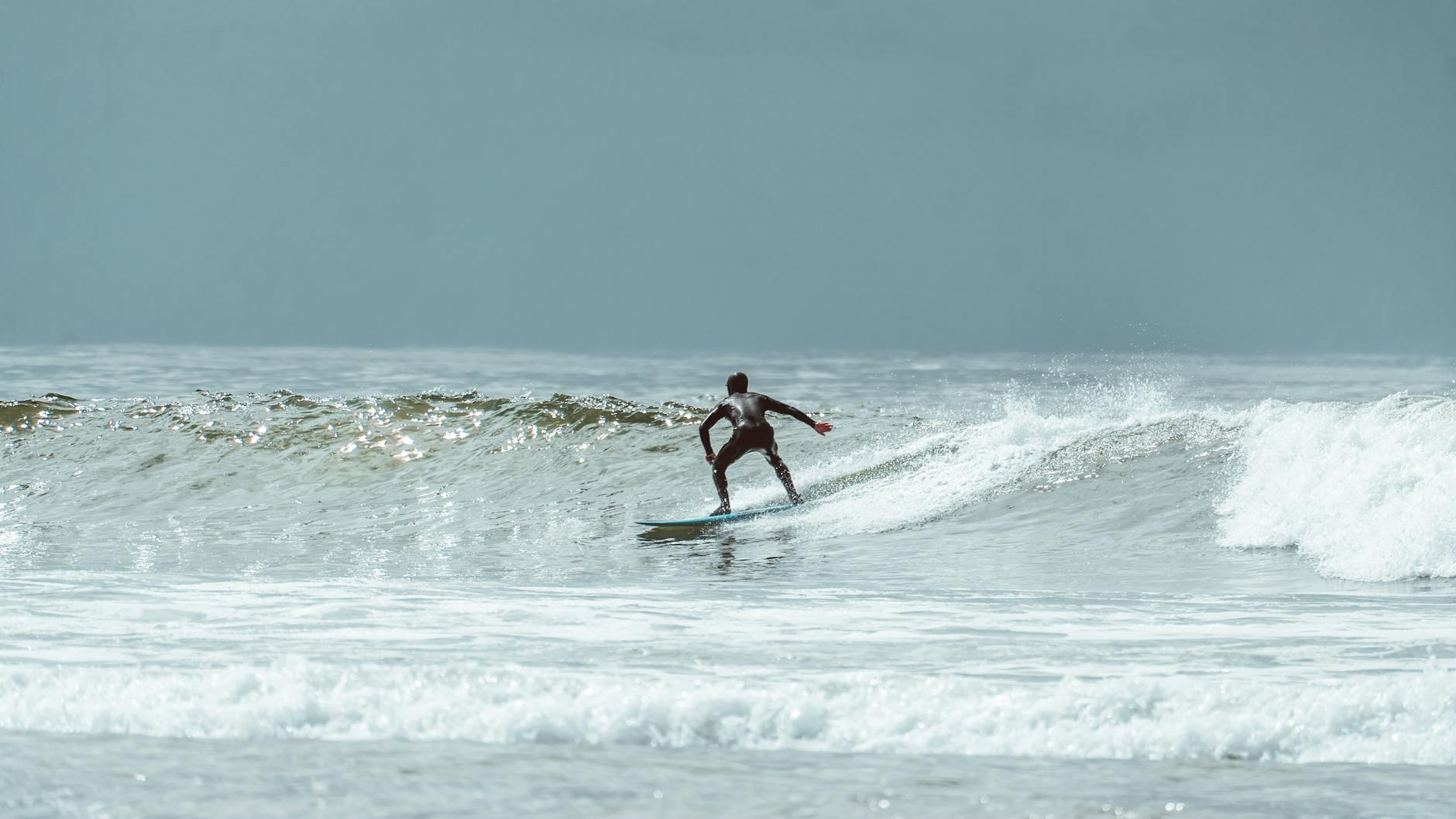 A surfer skillfully rides a wave in Tofino, BC, showcasing the thrill of water sports.