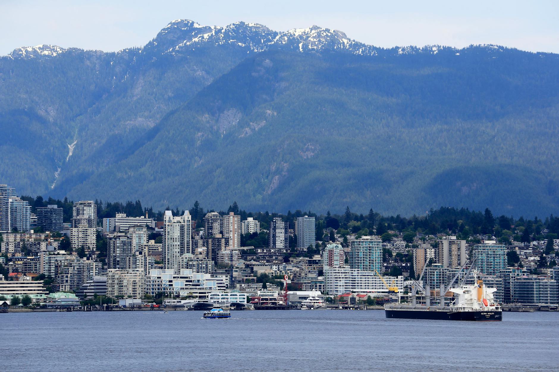 Skyline of North Vancouver with mountainous backdrop and waterfront view.